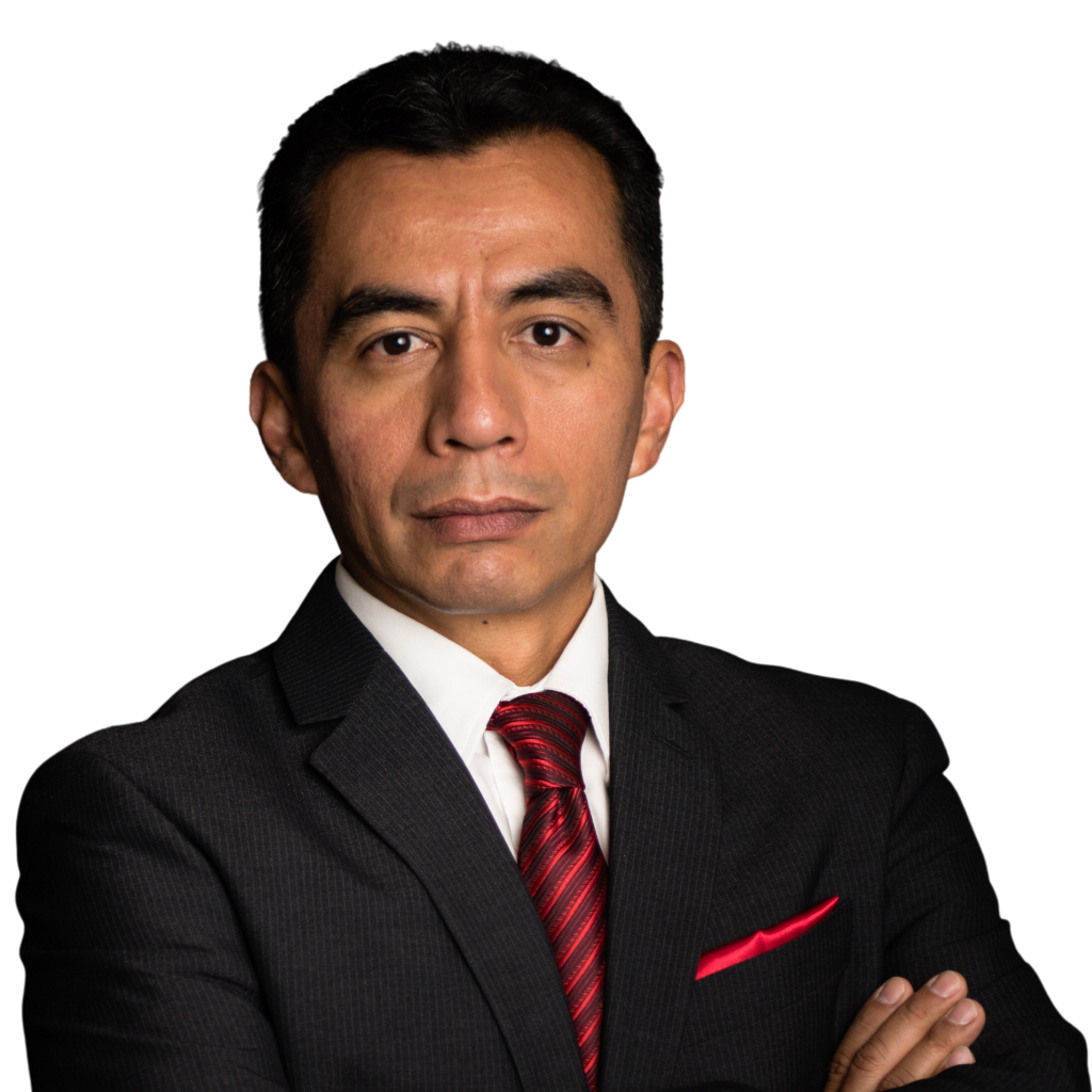 Head-and-shoulders portrait of a man in a dark suit and red striped tie, arms crossed against a black background.