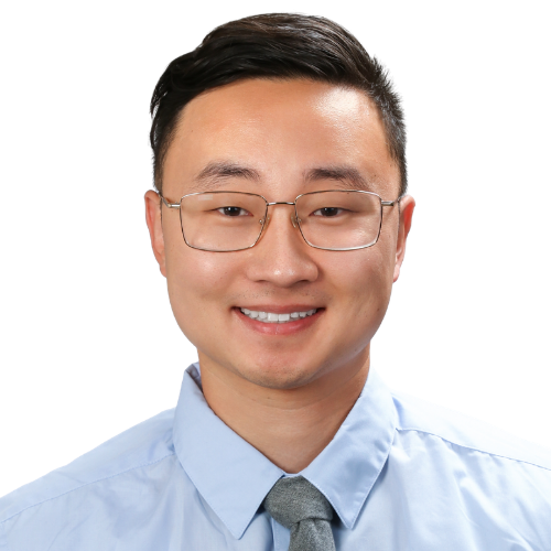 Smiling man in a light blue dress shirt and gray tie, wearing glasses, against a white background (head-and-shoulders portrait). -- Informative image for a professional profile.
